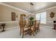 Formal dining room with modern lighting and a glass-top table, ideal for entertaining and meals at 4780 Woodruff Trce, Cumming, GA 30028
