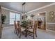 This dining room features neutral walls, a modern chandelier, and seating for six at 4780 Woodruff Trce, Cumming, GA 30028