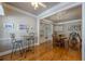 Open concept view of dining and breakfast nook with beautiful hardwood floors and a connected staircase at 4780 Woodruff Trce, Cumming, GA 30028