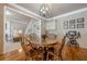 The dining room features hardwood floors, a round wood table, and stylish decor and adjacent to the living room at 4780 Woodruff Trce, Cumming, GA 30028