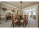 Dining room featuring neutral decor, open access to living areas, and a contemporary chandelier at 4780 Woodruff Trce, Cumming, GA 30028