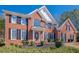 Charming brick home with black shutters, complemented by a well-maintained lawn and beautifully manicured landscaping at 4780 Woodruff Trce, Cumming, GA 30028