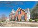 Elegant brick home showcasing classic architectural details, complemented by manicured landscaping and curb appeal at 4780 Woodruff Trce, Cumming, GA 30028