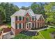 A brick home with black shutters, complemented by manicured landscaping and a verdant lawn at 4780 Woodruff Trce, Cumming, GA 30028