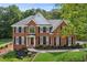 Beautiful brick home with lush green lawn, manicured landscaping and a classic architectural design at 4780 Woodruff Trce, Cumming, GA 30028