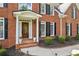 A classic brick facade showcases a front door with decorative glass and manicured landscaping at 4780 Woodruff Trce, Cumming, GA 30028