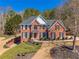 Charming brick home with mature trees and a welcoming front entrance at 4780 Woodruff Trce, Cumming, GA 30028