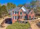 Traditional brick home with lush landscaping and a well-manicured lawn at 4780 Woodruff Trce, Cumming, GA 30028