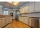 Large kitchen featuring stainless steel appliances, custom cabinetry, and a granite topped island at 4780 Woodruff Trce, Cumming, GA 30028
