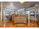 Open kitchen featuring stainless steel appliances, double ovens, custom island, and hardwood floors at 4780 Woodruff Trce, Cumming, GA 30028