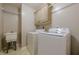 Functional laundry room with modern washer, dryer, utility sink, and cabinet storage at 4780 Woodruff Trce, Cumming, GA 30028