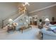 This open-concept living room showcases a staircase and flows seamlessly into the dining area at 4780 Woodruff Trce, Cumming, GA 30028