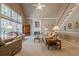 Spacious living room with a fireplace, staircase, large windows, and plenty of seating at 4780 Woodruff Trce, Cumming, GA 30028