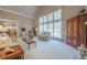 Bright living room featuring a vaulted ceiling, large windows, fireplace, and neutral decor at 4780 Woodruff Trce, Cumming, GA 30028