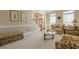 Elegant living room featuring a staircase, bright windows, and classic furniture arrangement at 4780 Woodruff Trce, Cumming, GA 30028