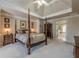 A luxurious bedroom features a four-poster bed, soft lighting, and easy access to the ensuite bath at 4780 Woodruff Trce, Cumming, GA 30028