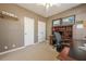 Office space with neutral walls, carpet, and built in shelving, and two doors at 4780 Woodruff Trce, Cumming, GA 30028