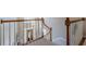 View of the staircase from the second floor landing with natural light and wood banisters at 4780 Woodruff Trce, Cumming, GA 30028