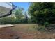 Spacious backyard features a wooden deck, mature trees, and an abundance of natural foliage at 1066 Cleavemark Dr, Clarkston, GA 30021
