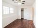 Bright bedroom featuring hardwood floors, a ceiling fan, and a closet at 2330 Lago Dr, Jonesboro, GA 30236