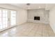 Spacious living area with tile floors, fireplace, and french doors for natural light at 2330 Lago Dr, Jonesboro, GA 30236