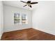 Bright bedroom featuring hardwood floors, a ceiling fan, natural light and a door leading to other rooms at 245 S Columbia Dr, Decatur, GA 30030