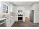 Updated kitchen featuring stainless appliances, granite countertops, white cabinets, and views to the exterior at 245 S Columbia Dr, Decatur, GA 30030