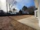 Spacious backyard with a patio, newly seeded lawn, and mature trees at 2716 Wynford Sw Ave, Marietta, GA 30064