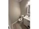 Charming half bathroom featuring wood-look floors and a modern vanity at 2716 Wynford Sw Ave, Marietta, GA 30064