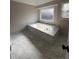 Bathroom featuring a large soaking tub with marble surround and tiled flooring at 2716 Wynford Sw Ave, Marietta, GA 30064