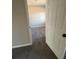 Comfortable bedroom featuring plush gray carpeting, a ceiling fan, and a door at 2716 Wynford Sw Ave, Marietta, GA 30064