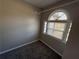 Bright bedroom featuring a half-moon window and plush gray carpet at 2716 Wynford Sw Ave, Marietta, GA 30064