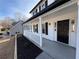 Elegant front entrance with a covered porch and a striking black front door at 2716 Wynford Sw Ave, Marietta, GA 30064