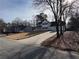 A beautifully landscaped front yard leads to a stately two-story house with black shutters and white trim at 2716 Wynford Sw Ave, Marietta, GA 30064