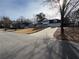 Front exterior featuring a newly seeded lawn, a long driveway, and mature trees at 2716 Wynford Sw Ave, Marietta, GA 30064