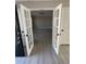 Hallway view with glass french doors and consistent luxury vinyl plank flooring throughout the home at 2716 Wynford Sw Ave, Marietta, GA 30064