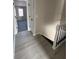 Bright hallway features gray wood flooring, neutral walls, and a stairway with white handrails at 2716 Wynford Sw Ave, Marietta, GA 30064