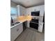 Renovated kitchen with stainless steel appliances, white cabinets, and granite countertops at 2716 Wynford Sw Ave, Marietta, GA 30064