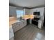 Corner view of the kitchen featuring white cabinets, quartz countertops, and stainless appliances at 2716 Wynford Sw Ave, Marietta, GA 30064