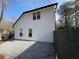 Side yard featuring white siding, black trim, and gravel covering; a truck is partially visible at 2716 Wynford Sw Ave, Marietta, GA 30064
