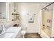 Updated bathroom features a shower and storage shelving at 3280 Spincaster Way, Loganville, GA 30052