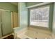 Bathroom featuring a shower and soaking tub with a sunny window at 3280 Spincaster Way, Loganville, GA 30052