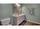 Bathroom boasts a double vanity, wood-look floors, and decorative mirrors at 3280 Spincaster Way, Loganville, GA 30052