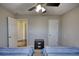 Bedroom with two twin beds, ceiling fan, and doors at 3280 Spincaster Way, Loganville, GA 30052