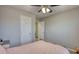Bedroom featuring a full bed, ceiling fan, and ensuite bath at 3280 Spincaster Way, Loganville, GA 30052