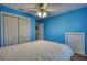 This is a cozy bedroom featuring blue walls, a ceiling fan, and a comfortable queen bed at 3280 Spincaster Way, Loganville, GA 30052