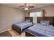 Bedroom with two twin beds, ceiling fan, and large window at 3280 Spincaster Way, Loganville, GA 30052