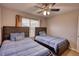 Bedroom with two twin beds, ceiling fan, and large window at 3280 Spincaster Way, Loganville, GA 30052