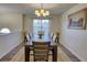 Formal dining room with wood floors, stylish lighting, and large windows for natural light at 3280 Spincaster Way, Loganville, GA 30052