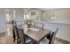 Dining room view into living area showcasing wood floors and natural lighting at 3280 Spincaster Way, Loganville, GA 30052
